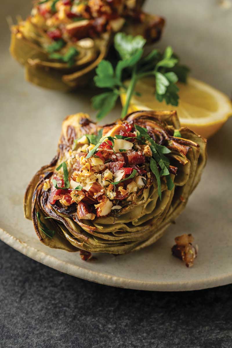 Roasted Artichokes with Serrano Ham and Marcona Almonds - Delicious Living